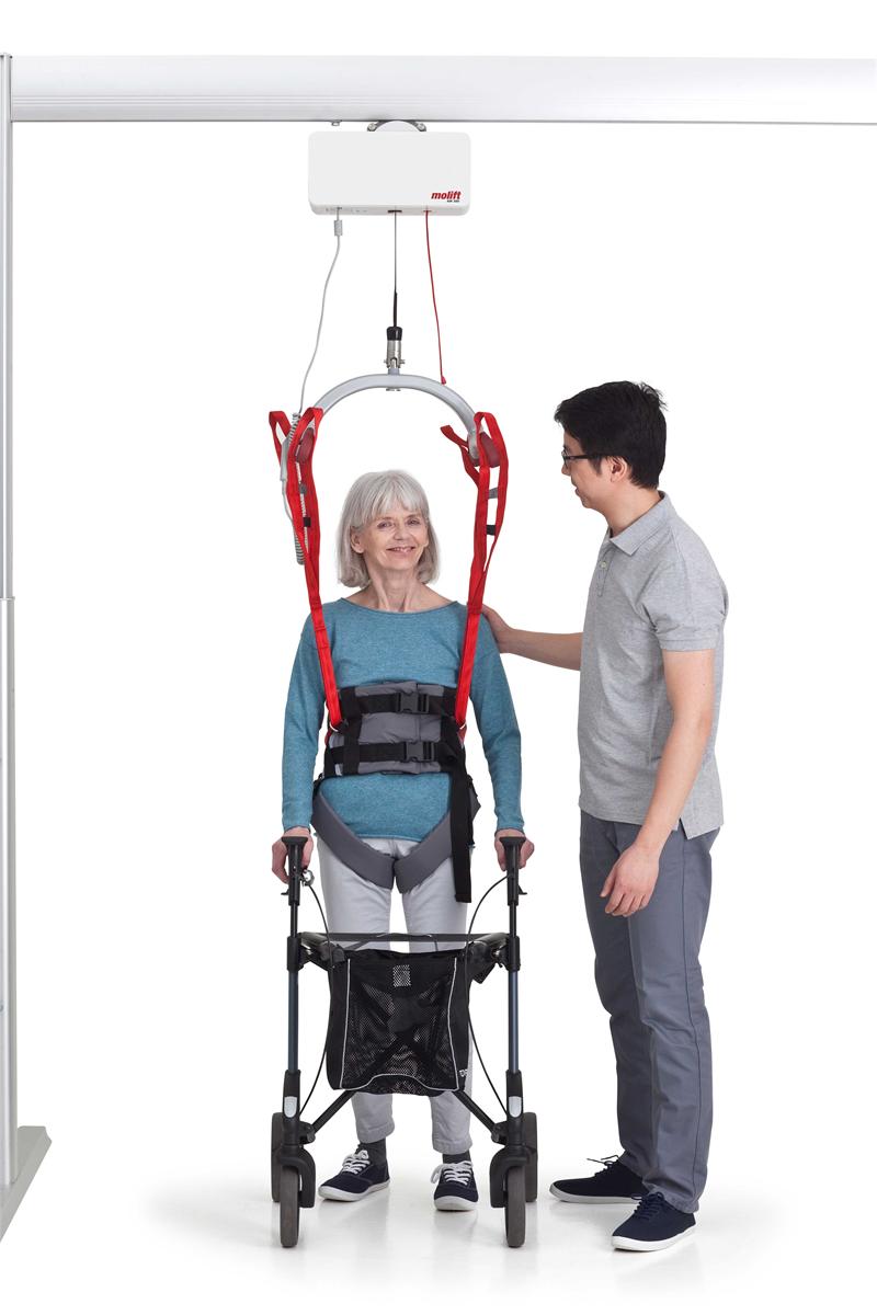 Molift RgoSling Ambulating Vest is best for those with some core stability|Molift RgoSling Ambulating Vest pictured with groin straps|Molift RgoSling Ambulating Vest with user, caregiver and walker|Molift RgoSling Ambulating Vest while gait training|Wide support on the back with groin straps for added protection|Sling bar loops and double buckle system for safety