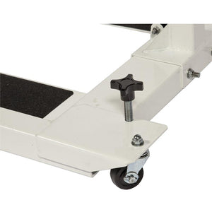 HCI Hydraulic UBE Table|Adjustable Arm adjusts height from 27"-37 and hydraulic pump|Turn knob allows user to lock casters in place to keep table more sturdy|Height adjustment allows for a variety of users to enjoy use of table|User with the HCI Hydraulic UBE Table and the Monark Ergometer