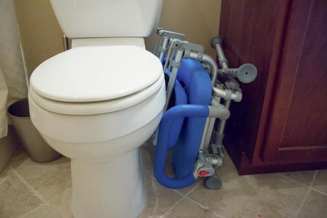 UltraCommode Folding Commode Chair in gray|UltraCommode Folding Commode Chair in blue|Fold compactly for ease of storage anywhere!|UltraCommode Folding Commode Chair folds compactly|Large commode pail comes standard|Chair is lightweight and portable|Seat can be used in the shower|UltraCommode Folding Commode Chair diagram