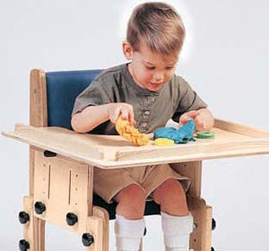 School Chair by TherAdapt with user (Armrests and tray)