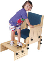 School Chair by TherAdapt with user (Armrests and adjustable footrest)