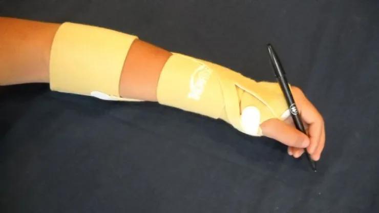 TheraTog Wrist and Thumb Positioning System for pediatric alignment.