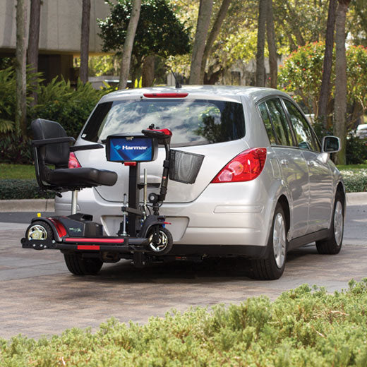 Harmar AL160 Profile Scooter Lift carrying scooter on mid-sized vehicle