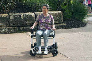 Zoomer - Black|Zoomer - Blue|Quick guide to the Zoomer|Lightweight 52# and easy to drive inside or outside|Joystick comes standard on right but can easily remount on the left by user|Comfort Seating|25 inch turning radius for easy indoor turns|Easy to fold - step 1 pull the cable|Easy to fold - step 2 fold the chair|Easy to fold - step 3 roll away|Slide up to the table or desk with no problem||Easily Scales up to a 10° incline|Fits in nearly any vehicle within seconds