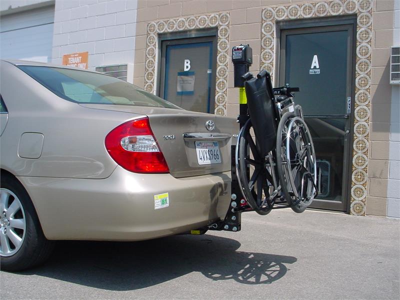 TriLift Ultra Lite Mobility Carrier holding manual wheelchair