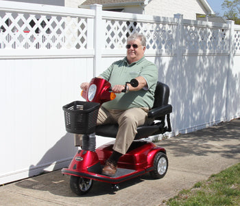 User on the Maxima 3-Wheel Scooter by Pride Mobility in Candy Apple Red
