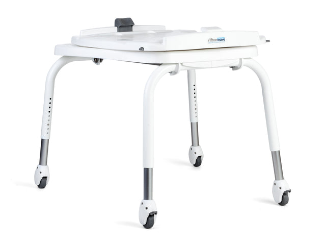 Tub transfer base for Rifton Wave Bath System|Sit in chair and roll back over the tub and set the brakes.|The bath chair is rotated 90° and feet move into tub.  Note: Take care to select the direction of the pivot, clockwise or counterclockwise (The tub transfer shown is pivoting clockwise.|Tub transfer legs fold for storage|Use the Tub Transfer manually or with a portable lift|2 leg heights, standard for tubs 20" or less from the floor and long for tubs greater than 20"|Wall hook included for wall storage