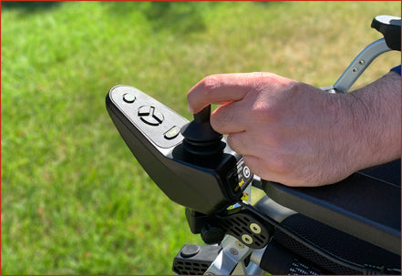Zoomer - Black|Zoomer - Blue|Quick guide to the Zoomer|Lightweight 52# and easy to drive inside or outside|Joystick comes standard on right but can easily remount on the left by user|Comfort Seating|25 inch turning radius for easy indoor turns|Easy to fold - step 1 pull the cable|Easy to fold - step 2 fold the chair|Easy to fold - step 3 roll away|Slide up to the table or desk with no problem||Easily Scales up to a 10° incline|Fits in nearly any vehicle within seconds