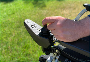 Zoomer - Black|Zoomer - Blue|Quick guide to the Zoomer|Lightweight 52# and easy to drive inside or outside|Joystick comes standard on right but can easily remount on the left by user|Comfort Seating|25 inch turning radius for easy indoor turns|Easy to fold - step 1 pull the cable|Easy to fold - step 2 fold the chair|Easy to fold - step 3 roll away|Slide up to the table or desk with no problem||Easily Scales up to a 10° incline|Fits in nearly any vehicle within seconds