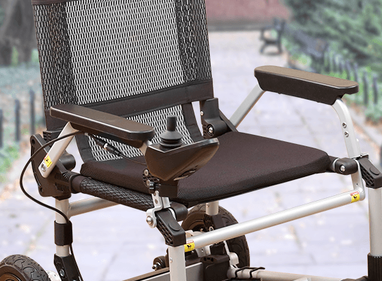 Zoomer - Black|Zoomer - Blue|Quick guide to the Zoomer|Lightweight 52# and easy to drive inside or outside|Joystick comes standard on right but can easily remount on the left by user|Comfort Seating|25 inch turning radius for easy indoor turns|Easy to fold - step 1 pull the cable|Easy to fold - step 2 fold the chair|Easy to fold - step 3 roll away|Slide up to the table or desk with no problem||Easily Scales up to a 10° incline|Fits in nearly any vehicle within seconds